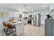 Bright kitchen with white cabinets, stainless steel appliances, and a bar-style counter with seating at 1367 21St St, Sarasota, FL 34234