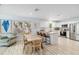 Modern kitchen with stainless steel appliances and white cabinets next to a dining area at 1367 21St St, Sarasota, FL 34234