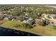 Aerial view of a home with screened-in porch overlooking a pond in a treed neighborhood at 14730 1St E Ave, Bradenton, FL 34212