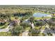 Beautiful aerial view of a home with backyard water views surrounded by mature trees at 14730 1St E Ave, Bradenton, FL 34212