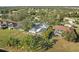 Aerial view of a backyard with a large, screened-in lanai and tropical landscaping at 14730 1St E Ave, Bradenton, FL 34212