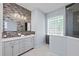 Modern bathroom boasts a double vanity, stylish tile accents, and a glass-block window at 14730 1St E Ave, Bradenton, FL 34212