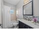 Bathroom featuring a shower-tub, a decorative mirror, and attractive countertop at 14730 1St E Ave, Bradenton, FL 34212