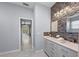 This bathroom features double sinks, decorative wall tiling, and light gray walls at 14730 1St E Ave, Bradenton, FL 34212
