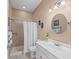 Bright bathroom with a shower, modern fixtures, vanity and a beach-themed decor at 14730 1St E Ave, Bradenton, FL 34212