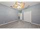 An empty bedroom showcasing gray walls, a light-colored floor, and a ceiling fan at 14730 1St E Ave, Bradenton, FL 34212