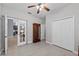 Bedroom featuring tile floors, ceiling fan, open door to other living spaces, and closet at 14730 1St E Ave, Bradenton, FL 34212
