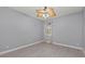 A bedroom with a ceiling fan, gray walls, and a window with blinds at 14730 1St E Ave, Bradenton, FL 34212