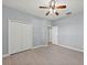 Bedroom showcasing light wood-look floors, a ceiling fan, a closet, and multiple doorways at 14730 1St E Ave, Bradenton, FL 34212