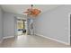 Spacious bedroom with light wood-look floors, a ceiling fan, and sliding glass doors to the pool at 14730 1St E Ave, Bradenton, FL 34212