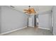 Bright bedroom with light wood-look floors, ceiling fan, and multiple doorways at 14730 1St E Ave, Bradenton, FL 34212