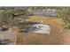 Aerial view of the community park with a playground, basketball court, and lake at 14730 1St E Ave, Bradenton, FL 34212