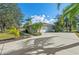 Home's exterior boasts a wide driveway, manicured landscaping, and a welcoming entrance, showcasing its curb appeal at 14730 1St E Ave, Bradenton, FL 34212