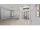 Inviting foyer with decorative front door, tile flooring, and ample natural light at 14730 1St E Ave, Bradenton, FL 34212
