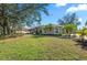 Lovely home featuring lush green lawn, mature landscaping, and great curb appeal at 14730 1St E Ave, Bradenton, FL 34212