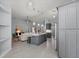 Open-concept kitchen with a center island and stainless steel appliances flowing to the living room at 14730 1St E Ave, Bradenton, FL 34212