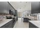 Modern kitchen featuring gray cabinets, quartz countertops, stainless steel appliances, and tile flooring at 14730 1St E Ave, Bradenton, FL 34212
