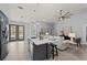 Open-concept kitchen and living area, featuring a kitchen island with bar stool seating at 14730 1St E Ave, Bradenton, FL 34212