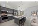 Bright kitchen featuring an island with bar stool seating and stainless steel appliances at 14730 1St E Ave, Bradenton, FL 34212