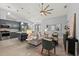 Open-concept living room with a large fan, modern furniture, and an attached kitchen at 14730 1St E Ave, Bradenton, FL 34212