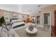 Open-concept living room with kitchen, lounge area, and access to other spaces at 14730 1St E Ave, Bradenton, FL 34212