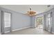 Main bedroom with fan and a slider that provides access to the pool area at 14730 1St E Ave, Bradenton, FL 34212