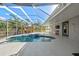 Screened pool area features a relaxing spa, patio seating, and seamless access to both indoor and outdoor spaces at 14730 1St E Ave, Bradenton, FL 34212