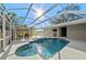 Sparkling pool with waterfall feature, screened enclosure, outdoor seating and lush surroundings at 14730 1St E Ave, Bradenton, FL 34212