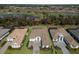 An aerial view showcases the property's prime location, overlooking a golf course with a serene lake at 14803 Derna Ter, Bradenton, FL 34211