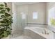 Bright bathroom featuring a glass shower, luxurious soaking tub, and mosaic tile accents at 14803 Derna Ter, Bradenton, FL 34211