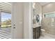 Well-lit bathroom featuring granite countertops, soft wall decor, and a tiled glass shower at 14803 Derna Ter, Bradenton, FL 34211