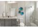 Stylish bathroom featuring a granite countertop, blue wall decor, and glass-enclosed shower at 14803 Derna Ter, Bradenton, FL 34211