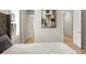 Bright bedroom featuring light wood floors, a tufted headboard, and abstract art at 14803 Derna Ter, Bradenton, FL 34211