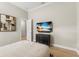 Serene bedroom boasts a beach-themed TV, dark wood dresser, and a comfortable quilted bedspread at 14803 Derna Ter, Bradenton, FL 34211