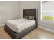 Comfortable bedroom featuring a tufted headboard, cozy bedding, light wood floors, and bright window at 14803 Derna Ter, Bradenton, FL 34211