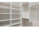 A walk-in closet featuring wooden clothing racks and white shelving at 14803 Derna Ter, Bradenton, FL 34211