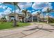 Inviting entryway of the clubhouse with tropical landscaping and palm trees that provide a luxurious resort feel at 14803 Derna Ter, Bradenton, FL 34211