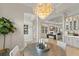 Open floor plan boasts a formal dining area with a modern chandelier and seamless flow to the living spaces at 14803 Derna Ter, Bradenton, FL 34211