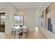 Dining room features a modern chandelier and a view of the screened-in outdoor pool at 14803 Derna Ter, Bradenton, FL 34211