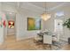 Bright dining room with a chandelier, neutral decor, and views to the property's exterior at 14803 Derna Ter, Bradenton, FL 34211