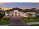 Stunning single-story home with a tile roof, brick driveway, and professionally landscaped grounds at 14803 Derna Ter, Bradenton, FL 34211