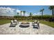 Outdoor fire pit with comfortable seating and views of manicured landscaping, perfect for entertaining friends at 14803 Derna Ter, Bradenton, FL 34211