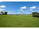 Scenic golf course view with lush green grass, blue sky, and scattered trees at 14803 Derna Ter, Bradenton, FL 34211