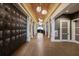 Hallway with dark wood lockers and accent lighting leading into a wine cellar and tasting area at 14803 Derna Ter, Bradenton, FL 34211