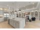 Gourmet kitchen boasts an island and stainless appliances, connected to a large living space at 14803 Derna Ter, Bradenton, FL 34211