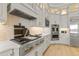 Modern kitchen features stainless steel appliances, gray cabinetry, and a stylish backsplash at 14803 Derna Ter, Bradenton, FL 34211