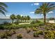 Beautifully landscaped grounds with lush foliage and mature trees surrounding a tranquil lake and golf course at 14803 Derna Ter, Bradenton, FL 34211
