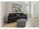 Cozy living room featuring a comfortable sofa, decorative pillows, and modern wall art at 14803 Derna Ter, Bradenton, FL 34211