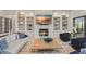Spacious living room offers a fireplace and custom built-in shelving at 14803 Derna Ter, Bradenton, FL 34211