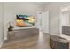 Modern living room showcasing a large TV, elegant console, and decorative orchid at 14803 Derna Ter, Bradenton, FL 34211